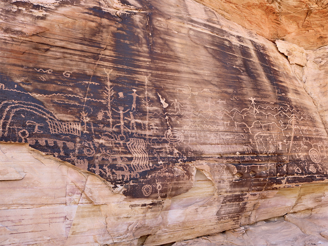 Petroglyphs on a dark rockface